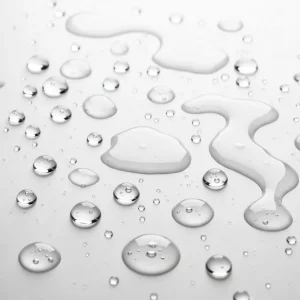 niacinamide droplets splashed naturally on a white background
